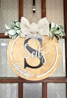 a wooden sign that says set 5 with a bow hanging on the front door window