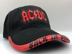 "This One Size Fits Most Unstructured Hat has the recognizable AC/DC logo! What makes this hat unique is the Amazing BRIMMTRIMM Hat Accessory that can be customized with any song/album/phrase. The BRIMMTRIMM is available in Red/White/Black/Pink color options (if you would like the LIGHTNING BOLTS GRAPHIC along with TEXT please include that in the personalisation section when ordering). Hat options include Classic White/Black/Khaki/Charcoal/Pink/Gray/Red.  Choose your BRIMMTRIMM and HAT choices i Adjustable Flat Brim Hats For Fans, Adjustable Fitted Hat With Curved Brim For Fans, Curved Brim Fitted Hat For Fan Merchandise, Adjustable Curved Brim Fitted Hat For Fans, Adjustable Baseball Cap For Fan Merchandise, Adjustable Christmas Cap, Ac Dc Band, Acdc Logo, Metal Stars