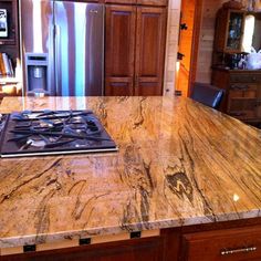 a kitchen island with a stove top in the middle