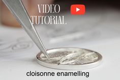 a close up of a coin with a knife in it's center and the words video tutorial above it