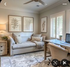 a living room filled with furniture and a laptop computer sitting on top of a desk