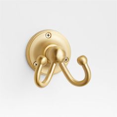 an image of a gold hook on a white wall