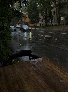 a rainy street with cars parked on it