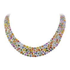 A stunning collar necklace, showcasing varying shapes and colors of vibrant sapphires weighing 161.55 carats total, set together seamlessly on 18K white gold. Accented by 14 small round brilliant cut diamonds weighing 0.80 carat total. An absolute work of art. Perfect for luxurious occasions. Roman Malakov is a custom house, specializing in creating anything you can imagine. If you would like to receive a special quote on a custom piece, please message or call us. Sapphire Diamond Necklace, Colored Diamond Jewelry, Diamond Tops, Multi Coloured Necklaces, Multicolor Jewelry, Tanzanite Jewelry, Pearl And Diamond Necklace, Shapes And Colors, Sparkle Necklace