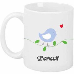 a white coffee mug with a blue bird sitting on a branch and the words spencer printed on it