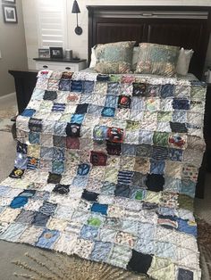 a bed with a large quilt on top of it