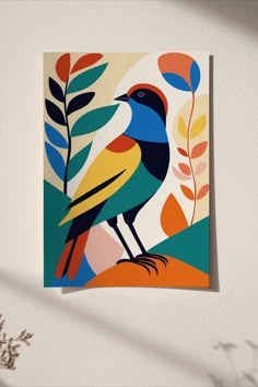 a colorful bird sitting on top of a leafy plant next to a white wall