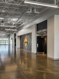 the inside of an office building with large windows and doors on each side of the room