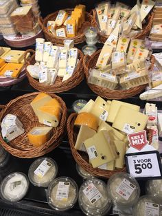 cheeses are displayed in wicker baskets on display