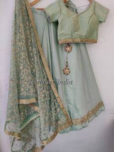 Looking for something special and unique to wear at your wedding? Look no further than our mint green lehenga choli dupatta! This beautiful piece of party wear is designed by one of India's leading fashion designers, and is perfect for bridesmaids, female guests, or even yourself as the bride. Made from tafetta silk fabric with a delicate mint green color, this lehenga choli dupatta will add an elegant touch to any outfit you choose to wear it with. Don't miss out on this must-have item for your Pista Green Cutdana Lehenga For Navratri, Pista Green Lehenga With Gota Work In Traditional Drape, Pista Green Lehenga With Gota Work, Pista Green Floor-length Art Silk Anarkali Set, Unstitched Pista Green Lehenga With Gota Work, Traditional Drape Pista Green Lehenga With Gota Work, Semi-stitched Pista Green Choli With Gota Work, Pista Green Choli With Gota Work For Diwali, Pista Green Floor-length Anarkali Set With Unstitched Blouse