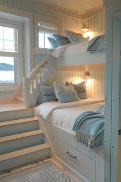 a bedroom with bunk beds and stairs leading to the upper floor, in front of a window