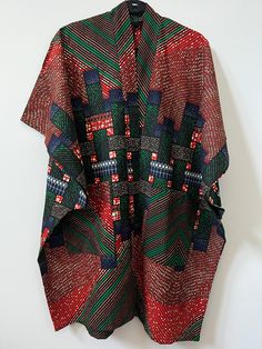 Up your style with this beautifully unique Kimono - they always make a statement! Crafted from African Wax Print fabric. Style with jeans, a skirt or dress. Open front Midi length Kimono style Relaxed, oversized fit Lightweight Short sleeves Patch front pockets 100% Cotton. One Size. Length = 38.5" African Print Kimono Jackets, Ankara Peplum Top And Skirt, Unique Kimono, African Print Kimono, Moda Kimono, African Wax Print Fabric, African Print Dress Ankara, Mode Kimono, Mommy Makeover