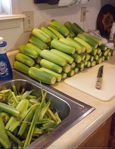 there are many pieces of corn in the kitchen sink and on the counter next to each other