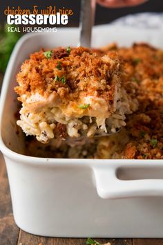 a casserole dish with chicken and rice in it is being lifted by a fork