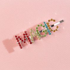 Honey, you're magical! So let everyone know with our Rainbow Magic Hair Pin. With a silver hair pin-style base, this gem features rhinestone lettering in red, yellow, green, blue, and orange - making for a kaleidoscope of magic✨ Care + Content: Rhinestones Metal Dimensions: 1" tall letters Tall Letters, Candles Jewelry, Silver Hair Pin, Rainbow Magic, Rhinestone Letters, Wooden Rainbow, Magic Hair, Rainbow Earrings, Blue And Orange