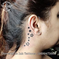 a woman with black stars behind her ear