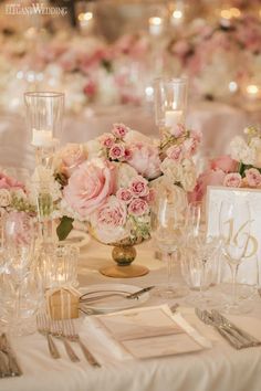 the table is set with flowers and candles