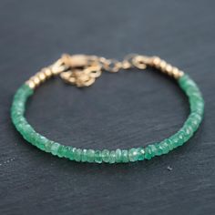 Stunning AAAA+ genuine zambian emeralds - untreated, undyed. Zambian emeralds are highly desirable because of their clarity and unique colour, they remain a lot more affordable than Colombian stones.  One of a kind, you are purchasing the exact bracelet in the photos Emerald: A stone of wisdom, love, and great harmony D E T A I L S △ Handmade in Canada △ Natural Zambian Emerald 2.5-3mm △ Faceted cut, rondel shape △ 14K gold filled accent clasp and extender △ Gemstones are 100% genuine  L E N G T Bracelet Emerald, Emerald Style, Gemstone Properties, Cotton Gift Bag, Emerald Bracelet, Dainty Bracelet, Zambian Emerald, Womens Jewelry, Rishikesh