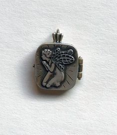 Sterling silver praying angel locket closes with a small magnet. Charm is 1" high x 3/4" wide. Can hold a small photo or written note. Spiritual Silver Locket Necklace For Memorial, Angel Locket, Praying Angel, Small Photos, Small Magnets, Locket Necklace, Locket, Jewelry Necklaces, Angel