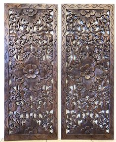 two carved wooden panels with flowers on them