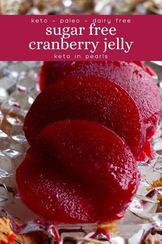 two pieces of cranberry jelly sitting on top of foil with the words, sugar free cranberry jelly keto in pairs