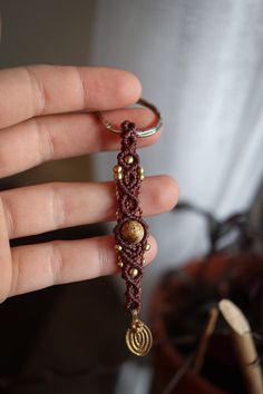 a hand holding a beaded key chain