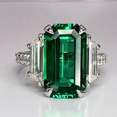 Emerald engagement ring 14K solid gold elongated emerald cut blue sapphire ruby emerald ring May birthstone ring Unique cocktail ring #7756 #EngagementRing #BlueSapphire #EmeraldRing #EmeraldCut #ElongatedEmerald #MayBirthstone #EmeraldGreen #14kSolidGold #UniqueRing #RubyRed Luxury Intricate Emerald Ring For Anniversary, Formal Emerald Ring With Rectangular Stone, Formal Emerald Ring With Diamond And Rectangular Stone, Formal Emerald Ring With Rectangular Diamond, Rectangular Emerald Ring With Accent Stones For Formal Occasions, Rectangular Emerald Ring With Accent Stones For Formal Events, Elegant Octagon Emerald Ring With Accent Stones, Elegant Emerald Cut Ruby Promise Ring, Emerald Cut Sapphire Birthstone Ring