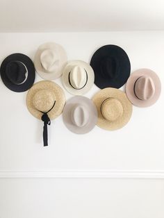 several hats are hanging on the wall