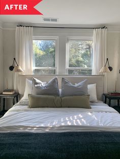 a bed sitting under two windows in a bedroom