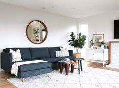 a living room filled with furniture and a large mirror