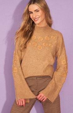 Tonal floral embroidery dances across this cozy mock-neck sweater knit with wide sleeves that add to the boho vibes. 23" length (size Medium) Mock neck Long sleeves 73% acrylic, 24% polyester, 3% spandex Hand wash, dry flat Imported Long Sleeve Knit Tops With Floral Embroidery, Floral Embroidery Knit Tops For Fall, Knit Long Sleeve Tops With Floral Embroidery, Knit Tops With Floral Embroidery For Fall, Embroidered Knit Tops For Fall, Knit Tops With Floral Embroidery And Long Sleeves, Beige Long Sleeve Sweater With Floral Embroidery, Beige Floral Embroidered Sweater For Fall, Fall Floral Embroidered Crew Neck Sweater