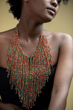 Unique African Maasai Handcrafted Beaded Necklace with an Elegant Look and Brilliant Finish. Circumference = 16 Inches/ 41 Centimeters. Color =Multi-Color Maasai Beads. Fringe = 10 Inches / 26 Centimeters. **GET FREE SHIPPING FOR ADDITIONAL ITEMS PURCHASED. Yes, Buy Multiple Items and pay shipping for 1 item only- The rest ships Free. (No Limits on the number of Multiple items). With a faster delivery time of 3 days via DHLExpress, Worldwide. Ordinary/Standard Shipping also available upon reques Traditional Multicolor Wooden Beaded Necklaces, Traditional Multicolor Wooden Beaded Necklace, Bohemian Bib Necklace With Beaded Chain, Bohemian Bib Necklace With Round Beaded Chain, Bohemian Bib Necklace With Round Beads, Artisan Multicolor Dangling Beads, Adjustable Multicolor Beaded Bib Necklace, Multicolor Wooden Beads For Festival, Bohemian Bib Necklaces With Colorful Round Beads