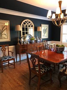 a dinning room table and chairs with blue walls