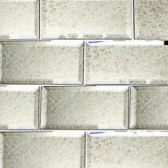 a close up view of a wall made out of white bricks with gray speckles