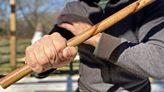 a man holding a wooden stick in his hand