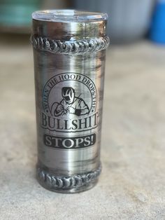 a shot glass with the words bullshike stops on it sitting on a table