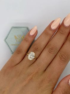 a woman's hand with a diamond ring on it