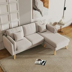 a white couch sitting on top of a rug in a living room