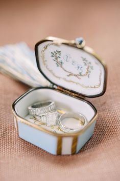 two wedding rings are in a small box