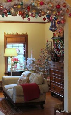 a living room filled with furniture and christmas decorations