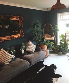 a living room filled with furniture and plants