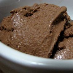 two scoops of chocolate ice cream in a white bowl