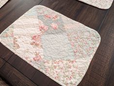 two rugs with flowers on them sitting on a wooden floor next to each other