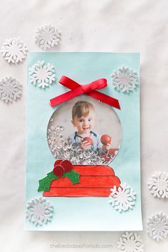 an ornament with snowflakes around it and a baby in the center