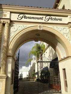 an entrance to a building with palm trees in the background