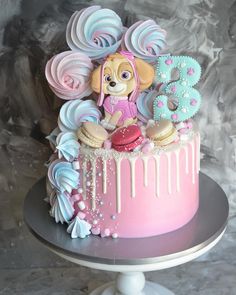 a pink and blue birthday cake decorated with icing