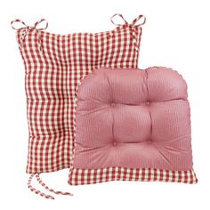 two red and white checkered pillows with ties on them, one has a pink seat cushion