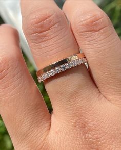 a woman's hand with a wedding ring on it, and the band has three stones