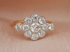 I am delighted to bring this beautiful vintage diamond daisy ring to the store.  Graded 20th Century, this ring fits perfectly into the 1960's era. Totalling 1.11ct of beautiful bright diamonds, these stones face up particularly white. This cluster is designed as a central round brilliant cut diamond surrounded by a halo of eight smaller diamond 'petals', with diamond accented shoulders.  This ring sits low to the hand at around 3mm above the finger, making this a beautiful piece to live in ever Edwardian Style, Daisy Ring, Hand Model, Professional Jewelry, Antique Boxes, Edwardian Fashion, Multi Stone Ring, Multi Stone, Vintage Diamond