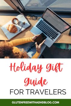 the words holiday gift guide for travelers on top of a table with laptops and croissants